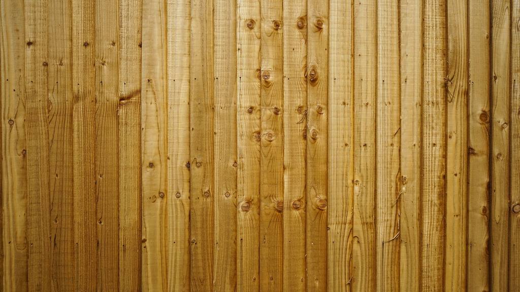 Close-up of a new closeboard timber garden fence with vertical featheredge boards